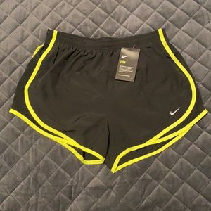 Women’s Nike size M black athletic shorts w neon yellow trim, NWT